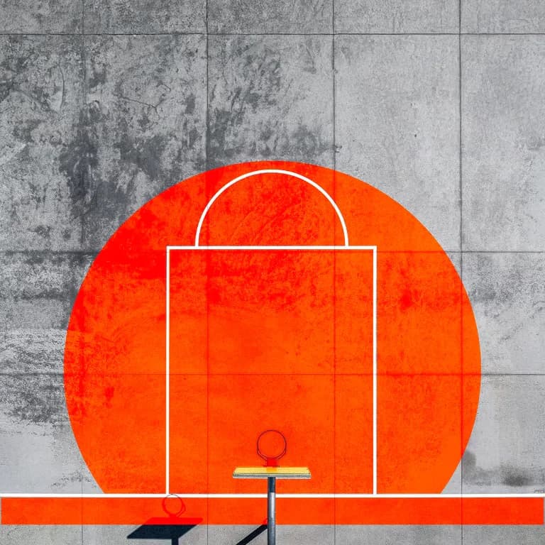 A basketball court wall painted with a large Dawn Orange rising sun