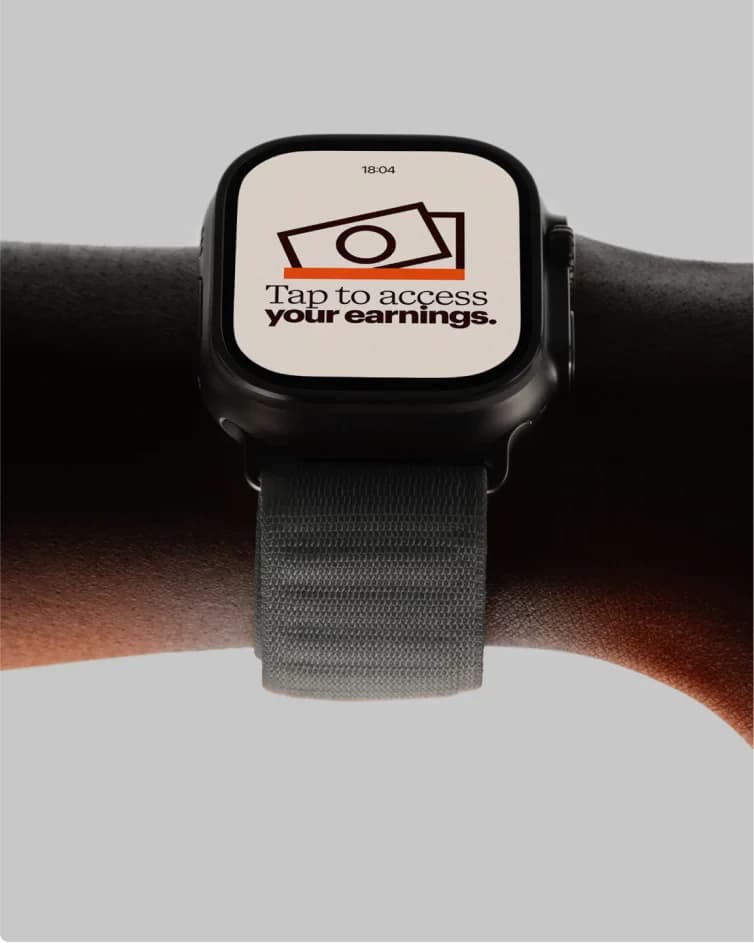 A black smartwatch on a wrist showing 'Tap to access your earnings.'